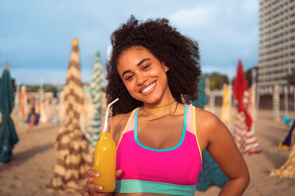 Black woman smiling wearing tinted sunscreen outdoors